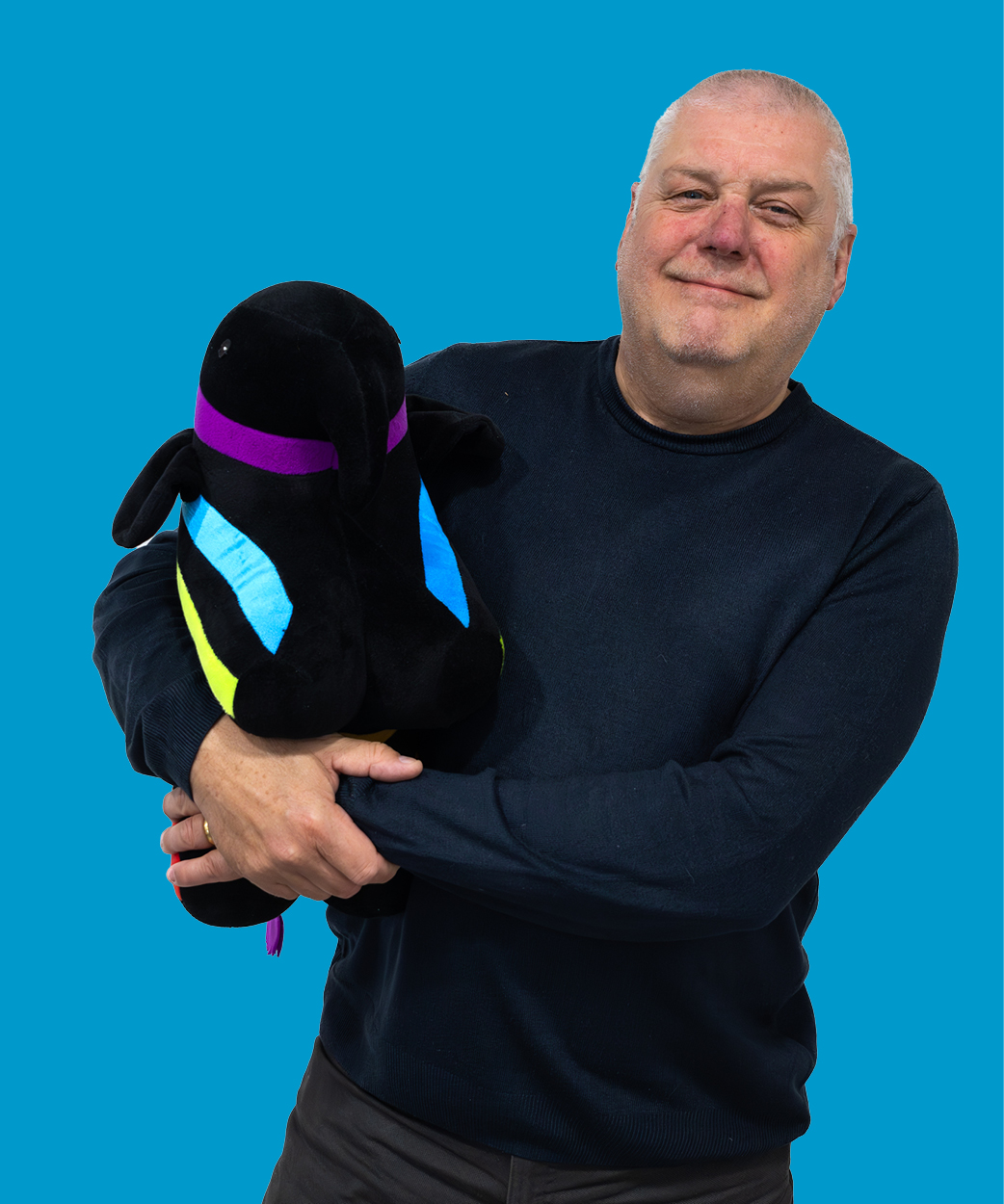 mark holding a caparol elephant on blue background